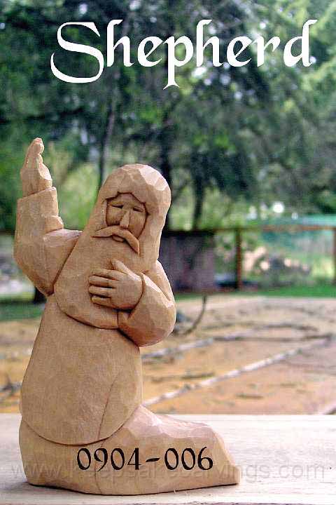 wood carving of shepherd kneeling